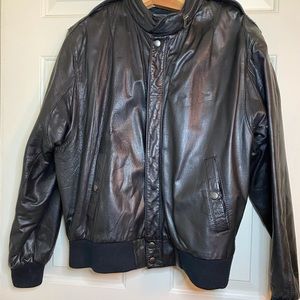 Wear Me Out: 1990s vintage leather jacket. Zippered collar stores a nylon hood.